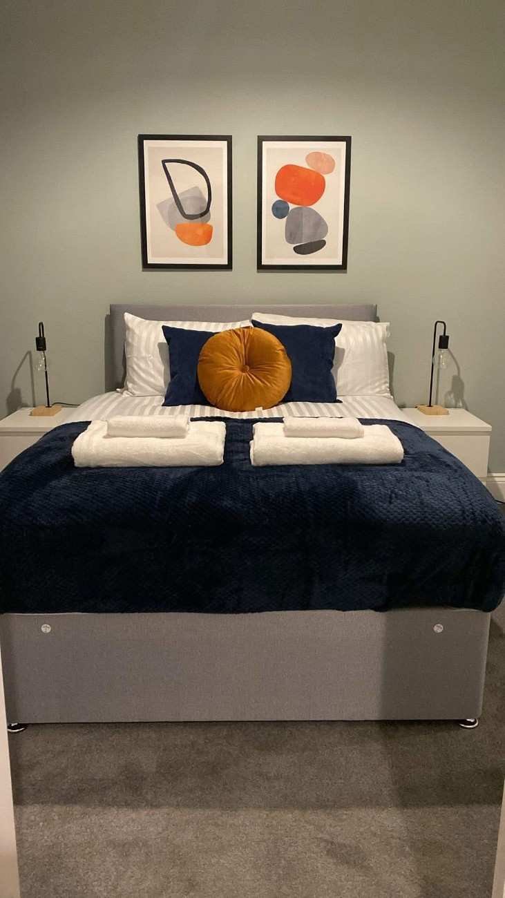 serviced apartment cleaning, a well-laid bed after cleaning by the cleaning team ltd